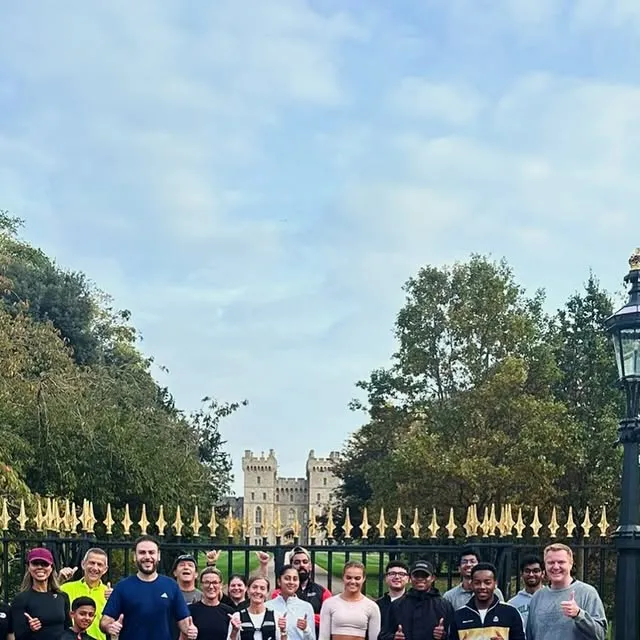 The Açai Club Run Club group at Windsor Castle in autumn